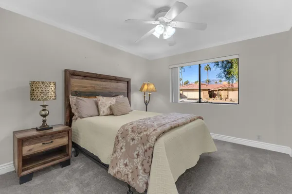 a bedroom with bed and window