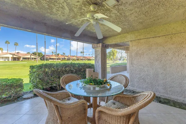 a view of a patio with table and chairs potted plants with wooden floor