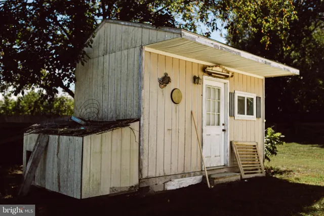 a view of a hallway with wooden floor and closet