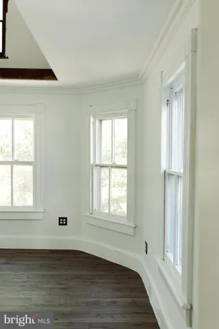 a bathroom with a sink a toilet a mirror and shower