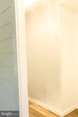 a backyard of a house with lots of plants and flowers