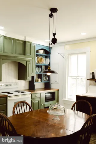 a dining room with furniture window and wooden floor