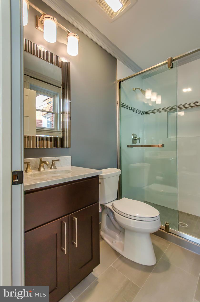 1128 Columbia Road Northwest Washington, DC 20009 - Photo 17 of 26 a bathroom with a sink toilet and mirror