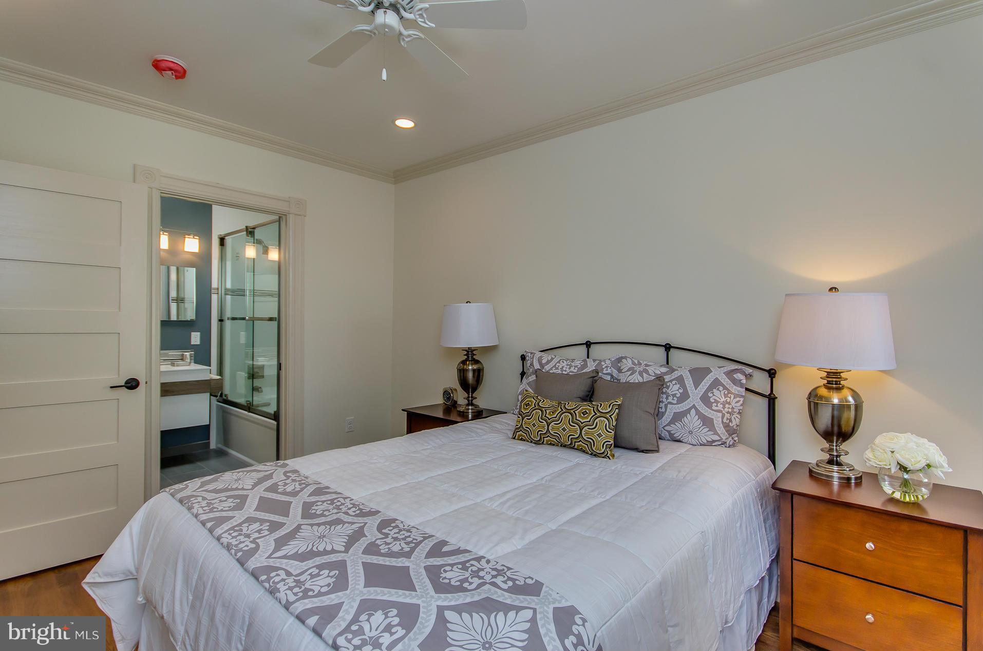 1128 Columbia Road Northwest Washington, DC 20009 - Photo 19 of 26 a bedroom with a bed and a chandelier