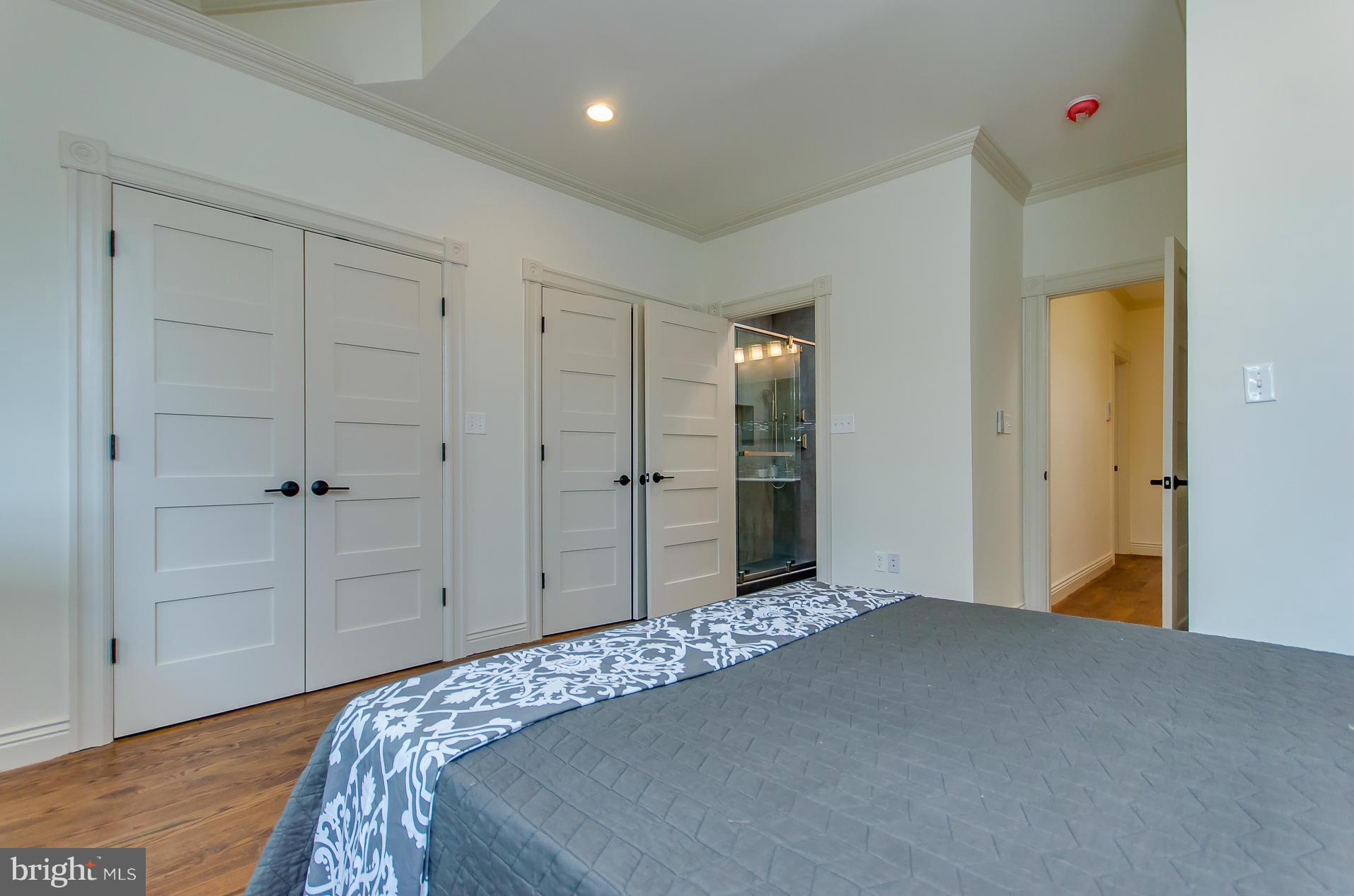 1128 Columbia Road Northwest Washington, DC 20009 - Photo 21 of 26 a bedroom with a bed and a closet