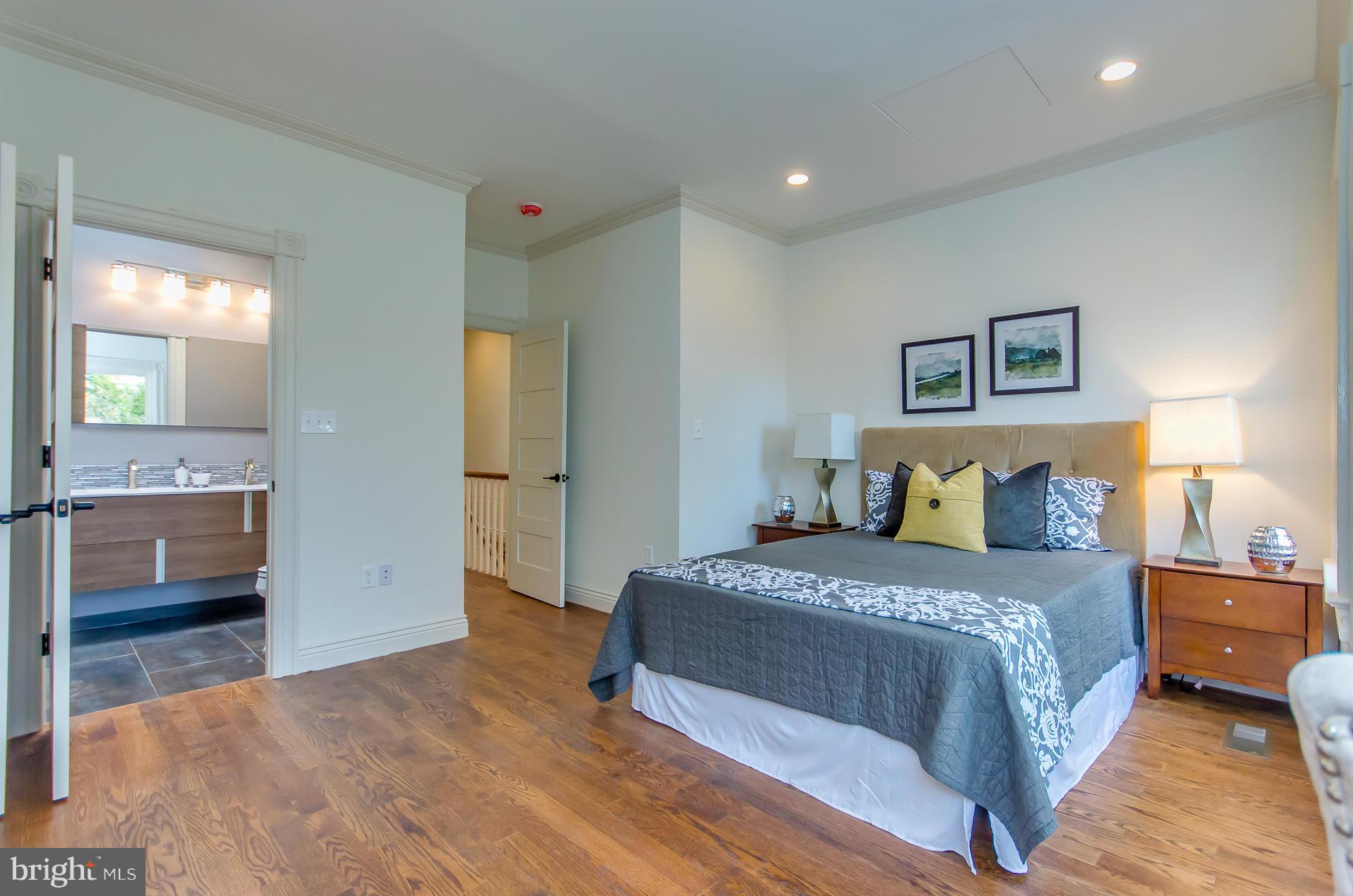 1128 Columbia Road Northwest Washington, DC 20009 - Photo 22 of 26 a bedroom with a bed and a view of living room