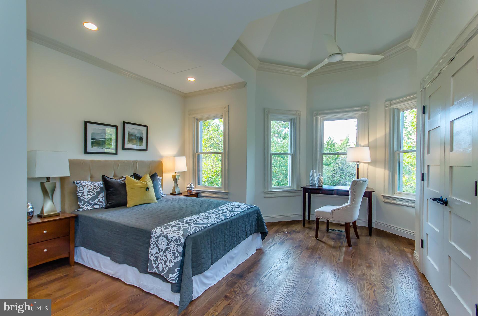 1128 Columbia Road Northwest Washington, DC 20009 - Photo 23 of 26 a bedroom with a bed a table and a large window