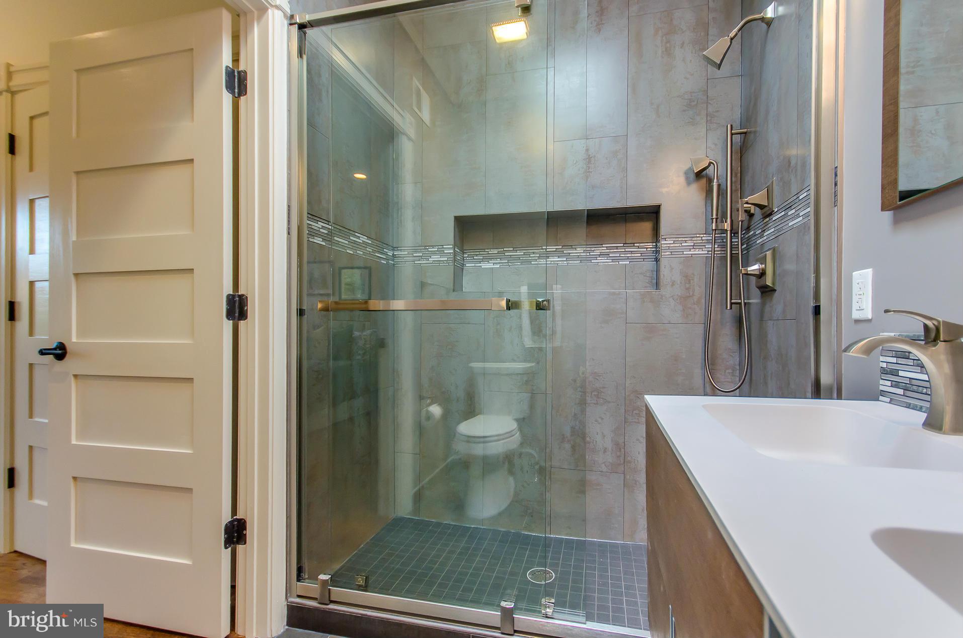 1128 Columbia Road Northwest Washington, DC 20009 - Photo 24 of 26 a bathroom with a shower and a sink