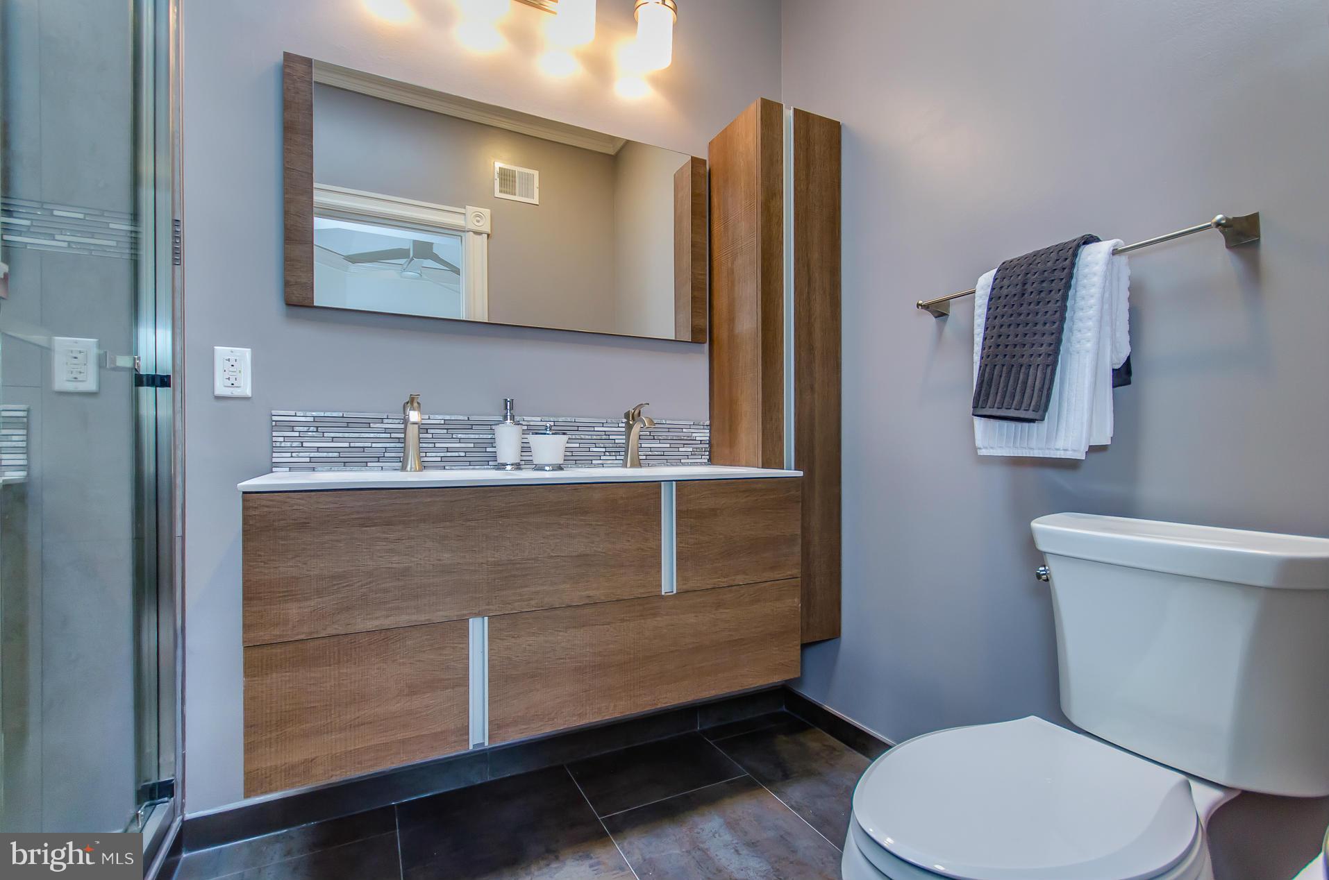1128 Columbia Road Northwest Washington, DC 20009 - Photo 25 of 26 a bathroom with a toilet sink and mirror