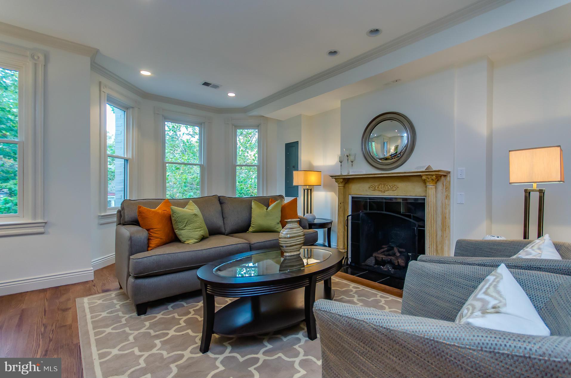 1128 Columbia Road Northwest Washington, DC 20009 - Photo 5 of 26 a living room with furniture and a fireplace