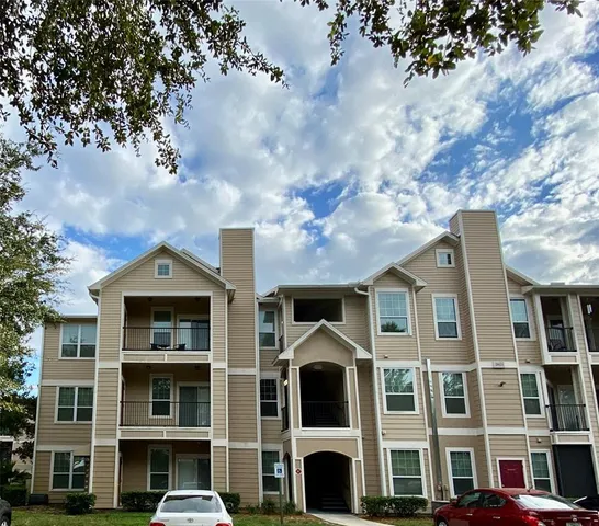 a front view of a building with a tree