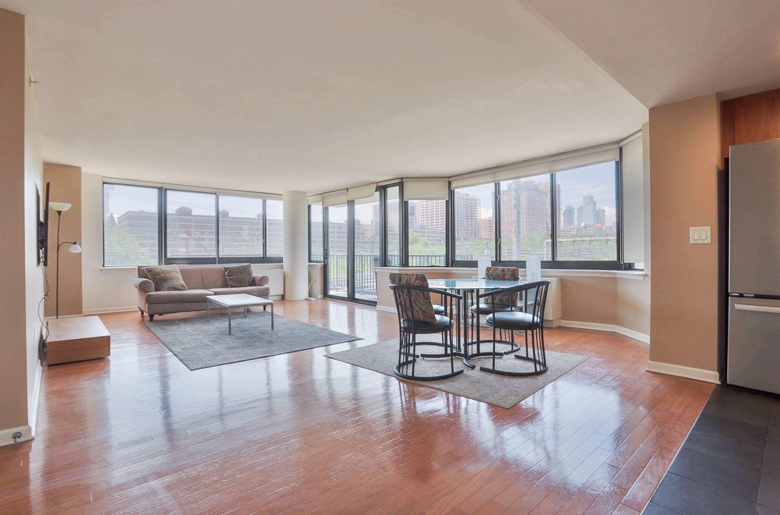 700 Grove Street, Unit 4F Jersey City, NJ 07310 - Photo 2 of 30 a living room with furniture and a large window