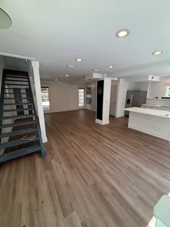 a view of an empty room and wooden floor