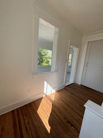 a view of a bedroom with wooden floor and bedroom
