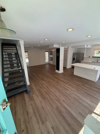 a view of kitchen and hall with wooden floor