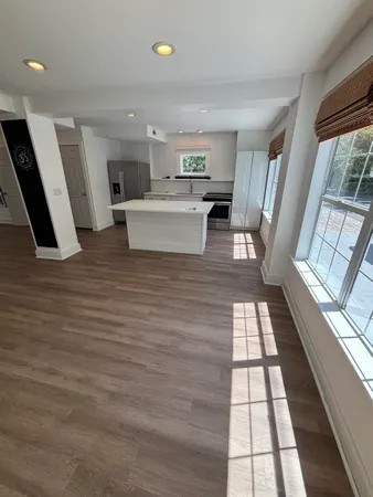 a view of a living room with a sink and wooden floor