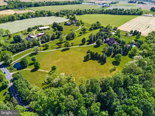 an aerial view of a houses with a lake view