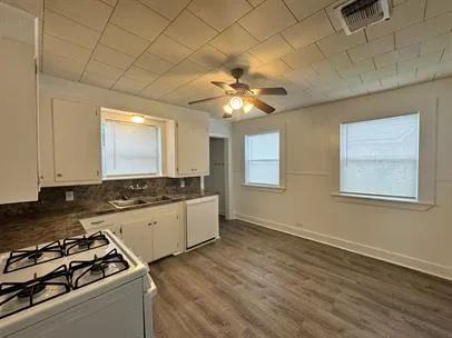 a kitchen with stove and cabinets
