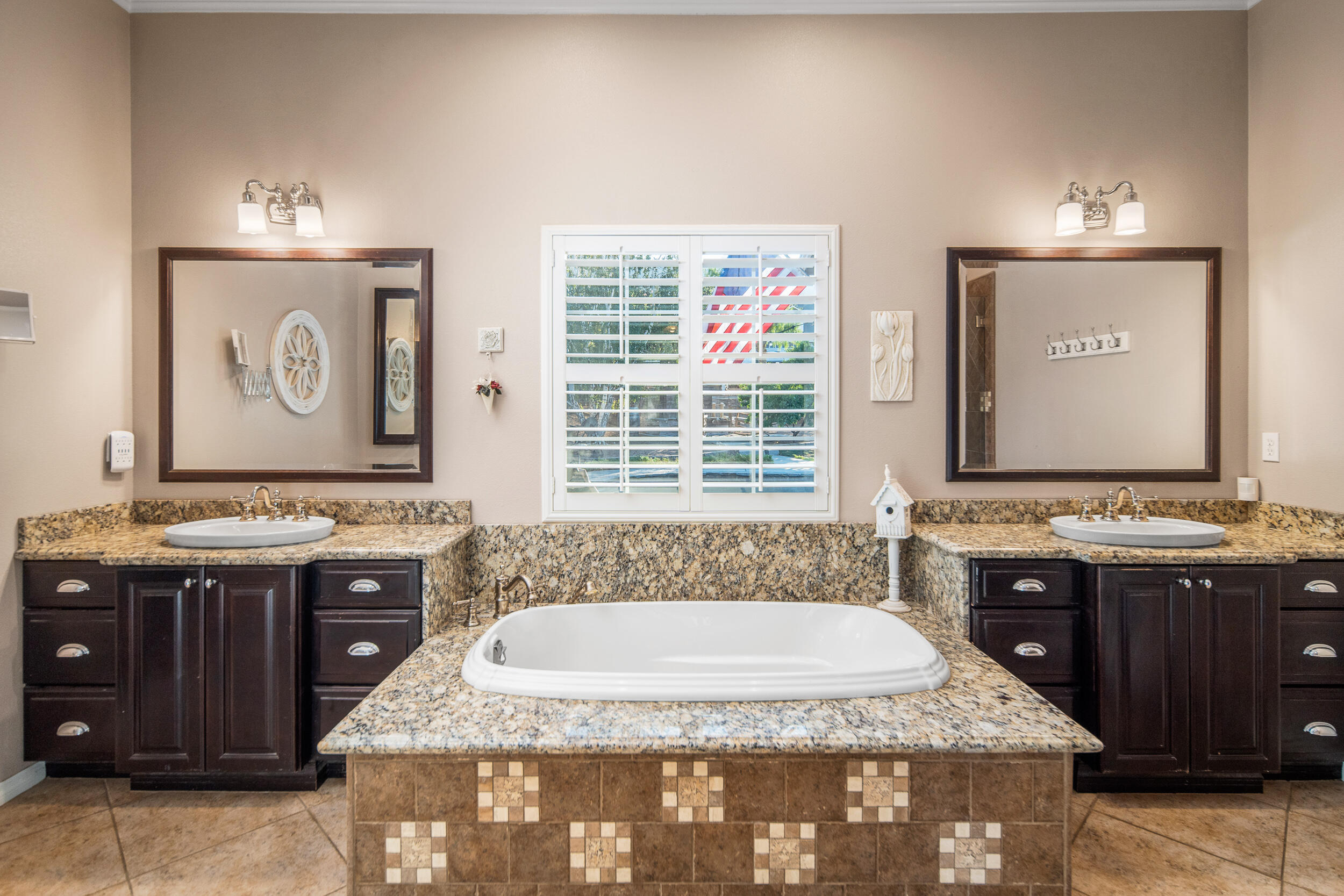 4114 9th Street Acton, CA 93510 - Photo 21 of 63 a bathroom with a granite countertop tub a sink and a window