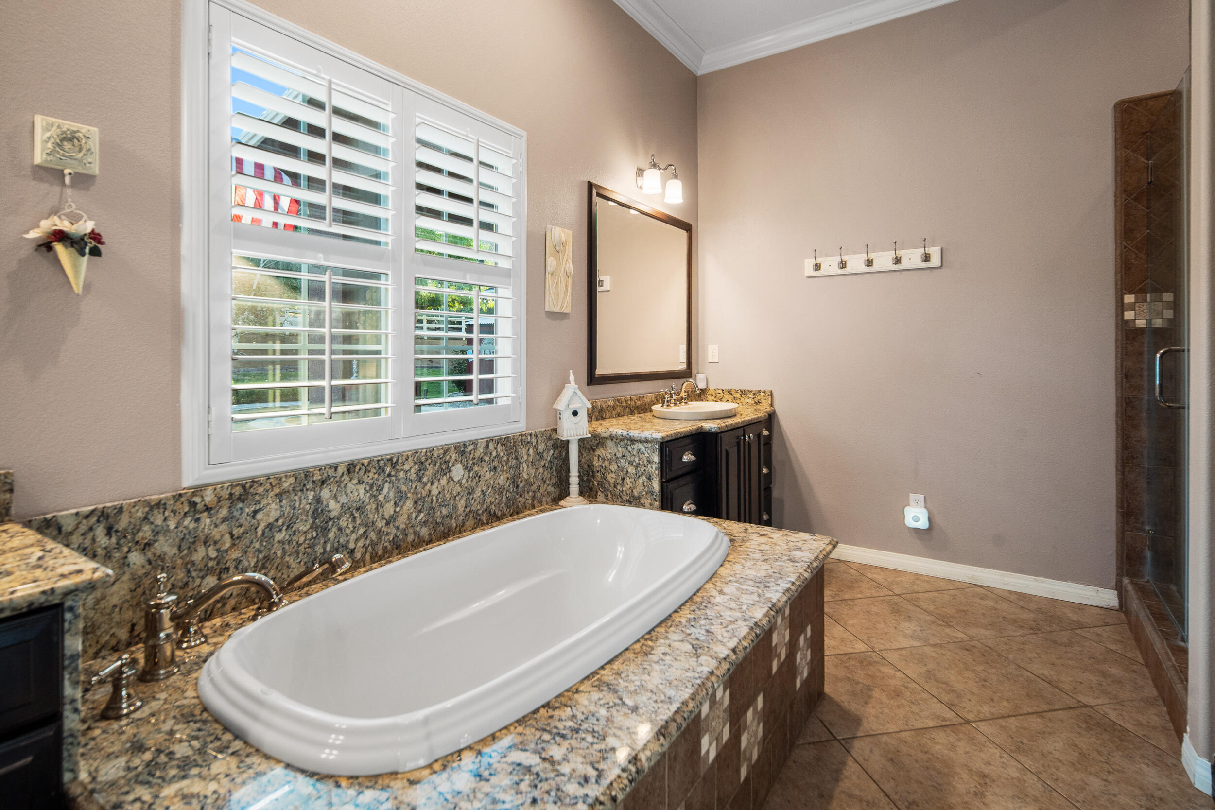 4114 9th Street Acton, CA 93510 - Photo 23 of 63 a bath tub sitting in a bathroom next to a window