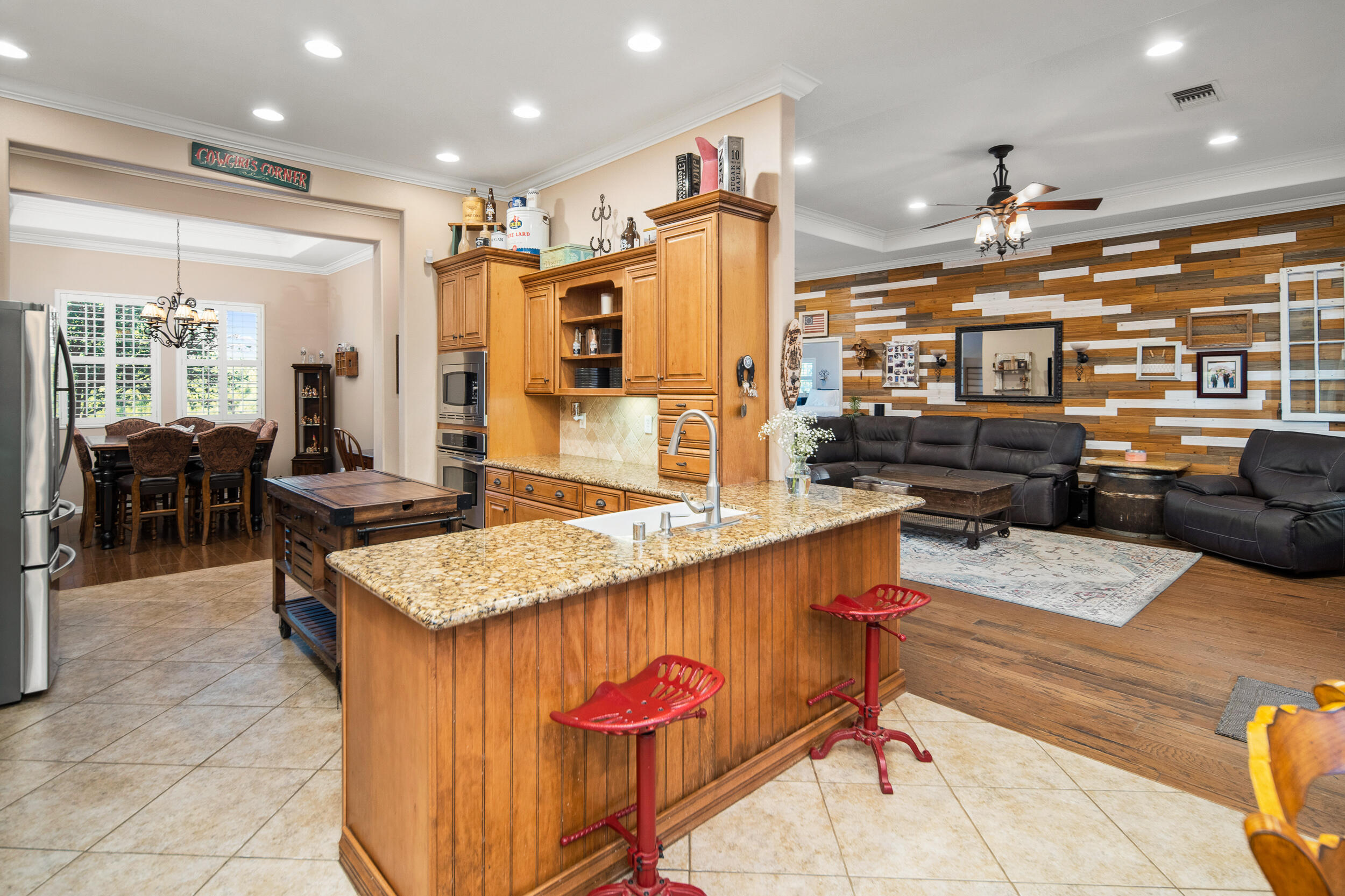 4114 9th Street Acton, CA 93510 - Photo 10 of 63 a kitchen with stainless steel appliances kitchen island granite countertop a table chairs in it and wooden floors