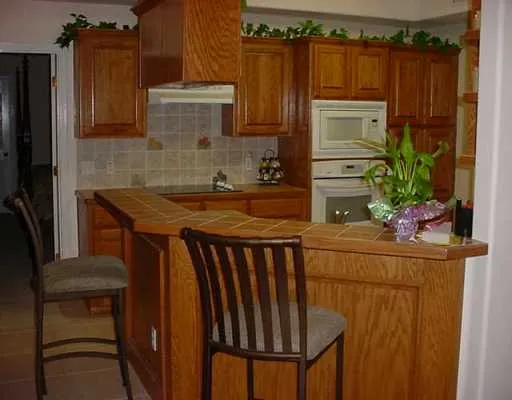 a kitchen with a sink a refrigerator and a stove