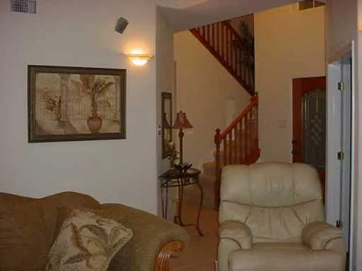 a bedroom with furniture and a painting