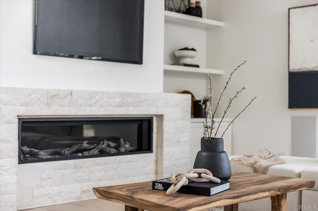 2942 Lone Jack Road Encinitas, CA 92024 - Photo 13 of 23 a living room with a fireplace and a flat screen tv