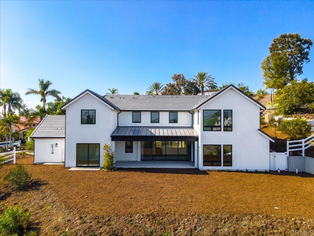 2942 Lone Jack Road Encinitas, CA 92024 - Photo 22 of 23 a front view of a house with a yard and garage