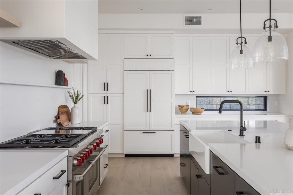 2942 Lone Jack Road Encinitas, CA 92024 - Photo 8 of 23 a kitchen with white cabinets and white appliances