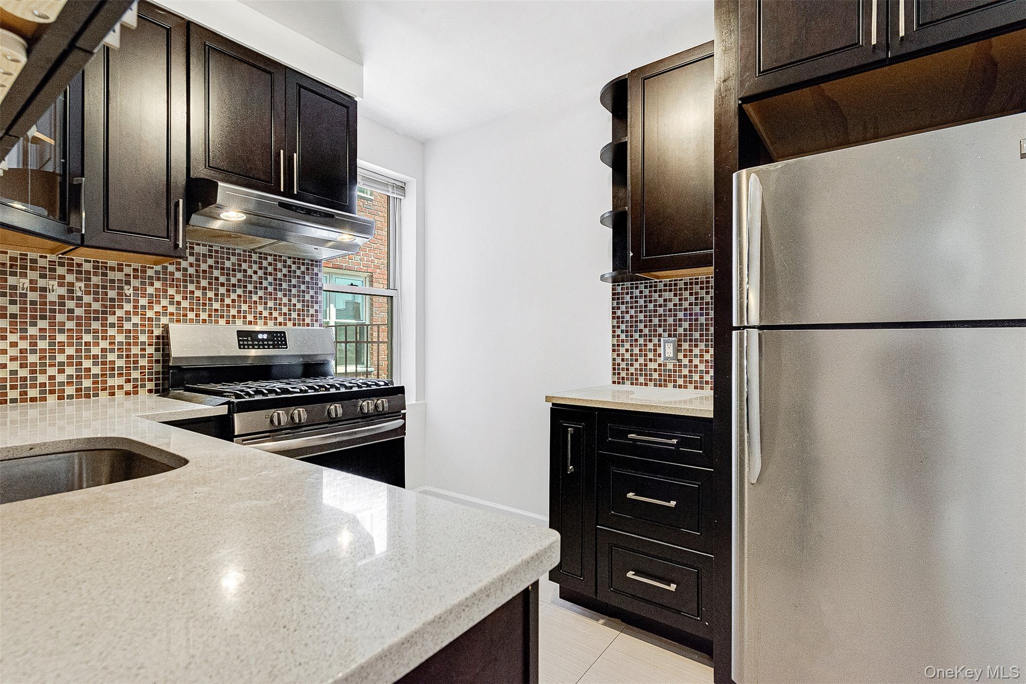 67-38 108th Street, Unit D47 Queens, NY 11375 - Photo 9 of 24 a kitchen with a refrigerator and a sink