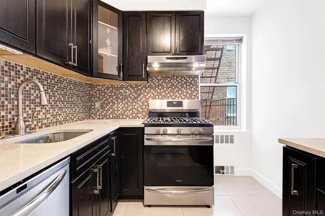 a kitchen with cabinets and stainless steel appliances