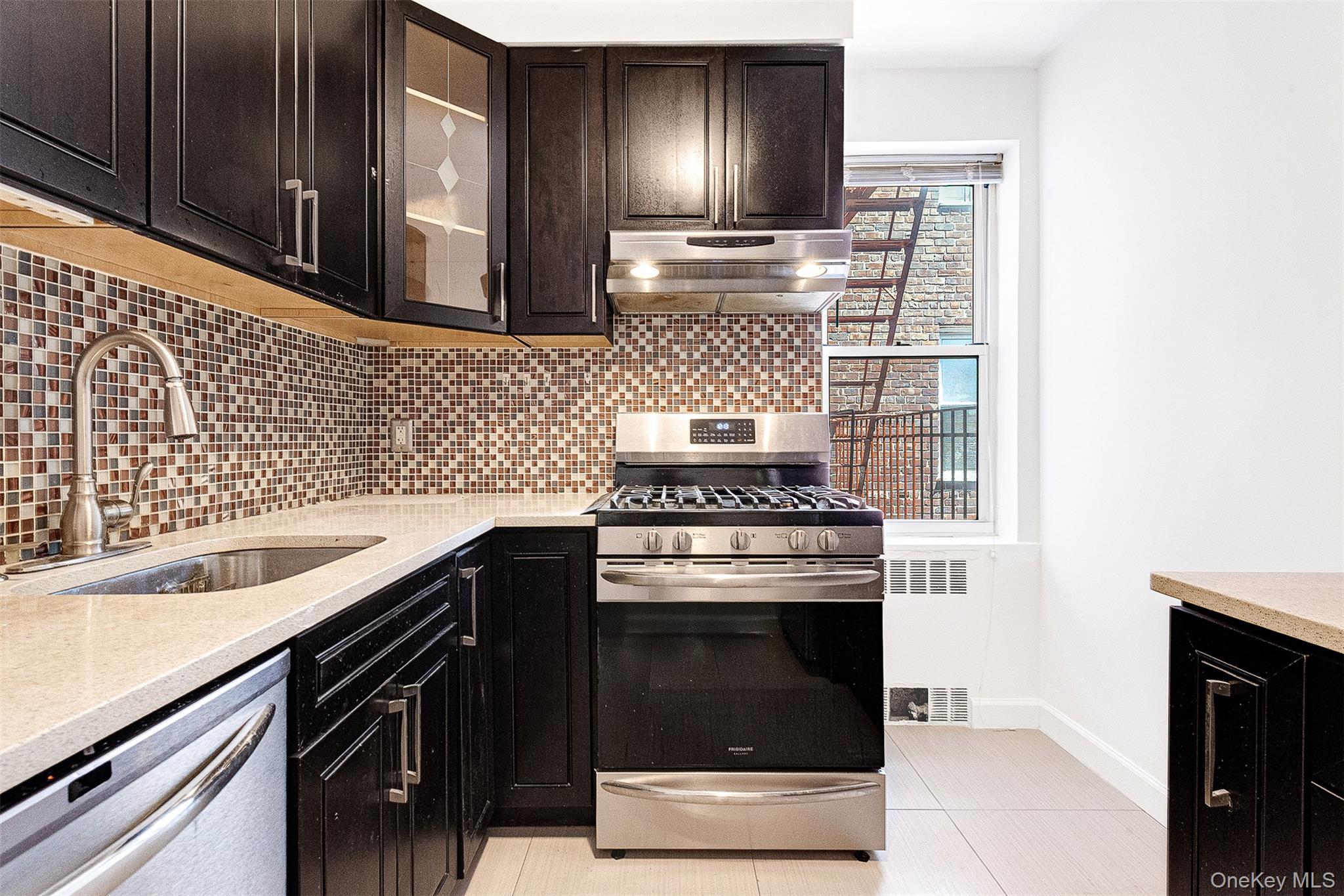 67-38 108th Street, Unit D47 Queens, NY 11375 - Photo 10 of 24 a kitchen with cabinets and stainless steel appliances
