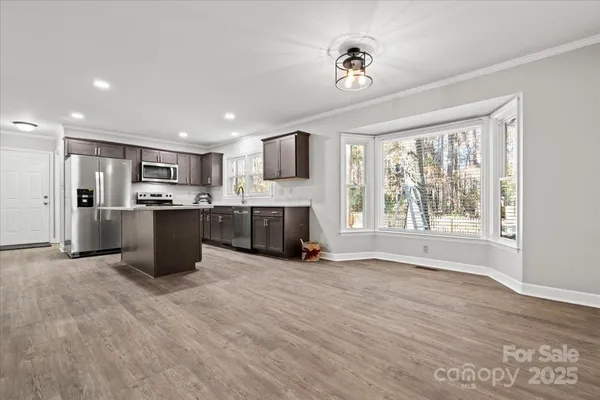 a view of kitchen with microwave and windows