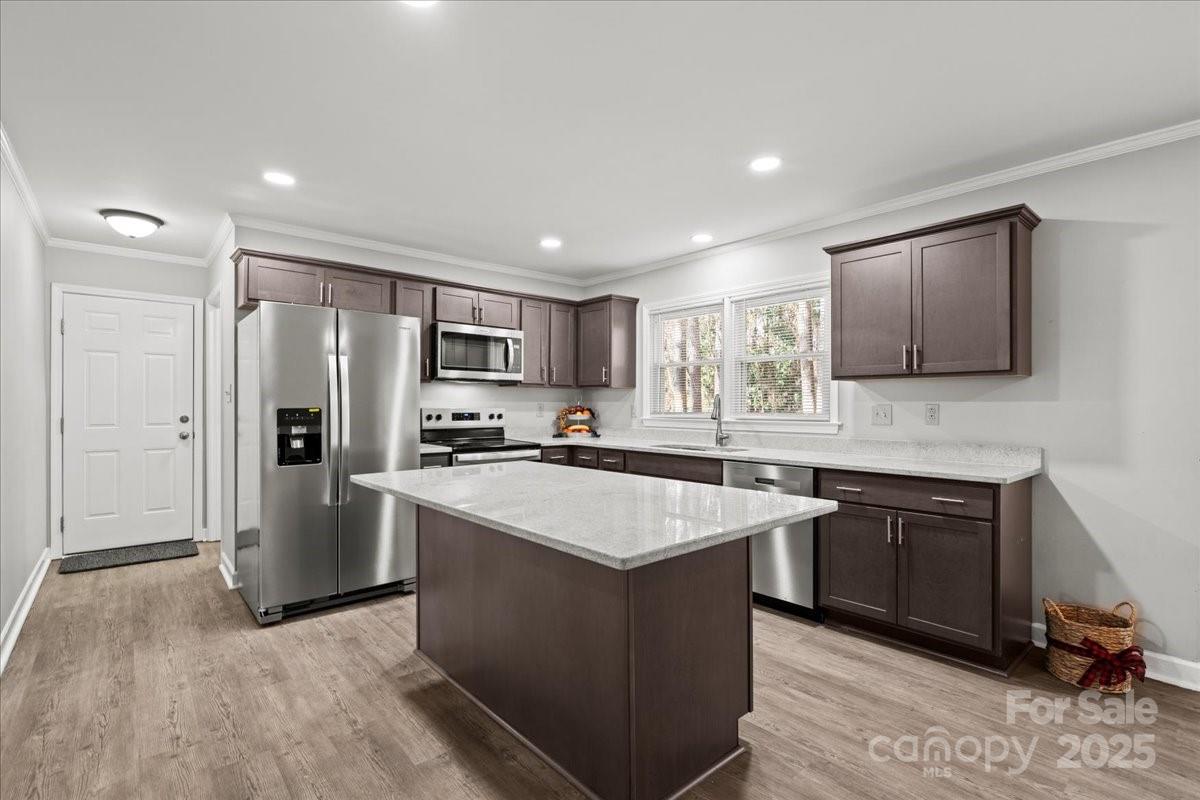 305 Virginia Avenue Cheraw, SC 29520 - Photo 19 of 48 a kitchen with stainless steel appliances granite countertop a sink stove and refrigerator