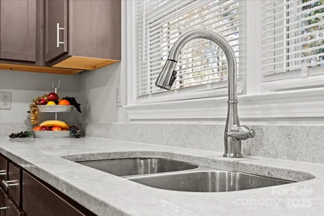 a kitchen with a sink and a large window