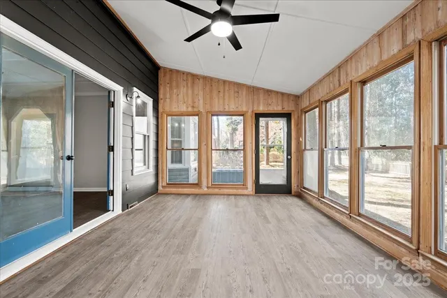 a view of an entryway with wooden floor