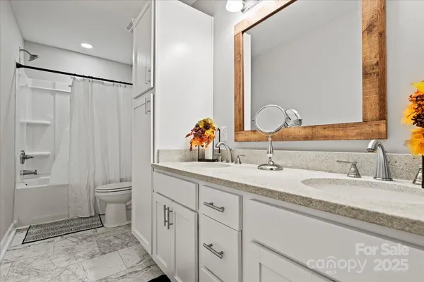 a bathroom with a double vanity sink and a mirror