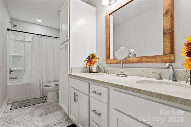 a bathroom with a double vanity sink and a mirror
