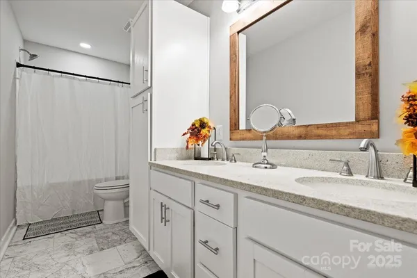 a bathroom with a double vanity sink and a mirror
