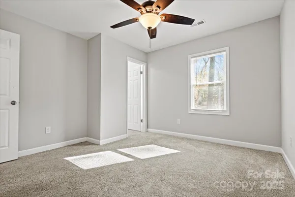 a view of a livingroom with a ceiling fan and window