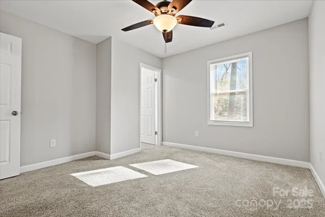 a view of a livingroom with a ceiling fan and window