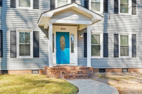 a view of a brick house with many windows
