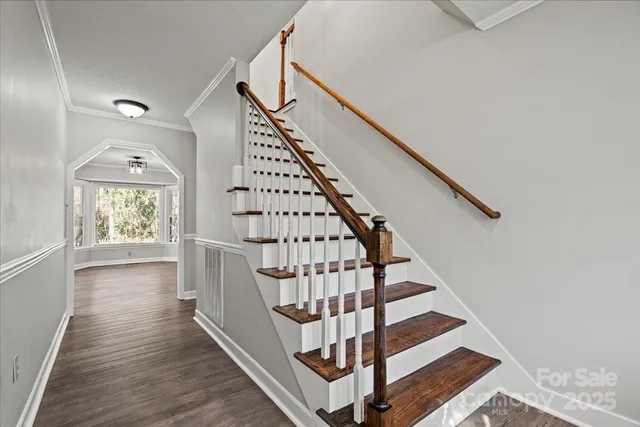 a view of entryway with wooden floor and stairs
