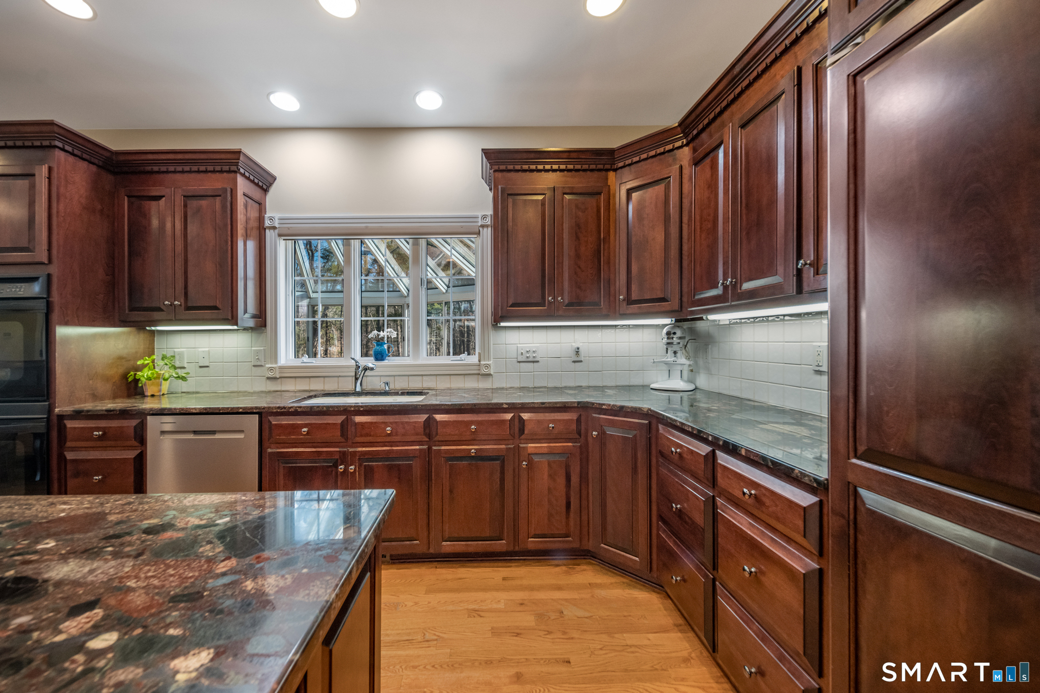 11 Kachina Way Madison, CT 06443 - Photo 12 of 40 a kitchen with stainless steel appliances granite countertop wooden cabinets a oven and granite counter tops with a large window