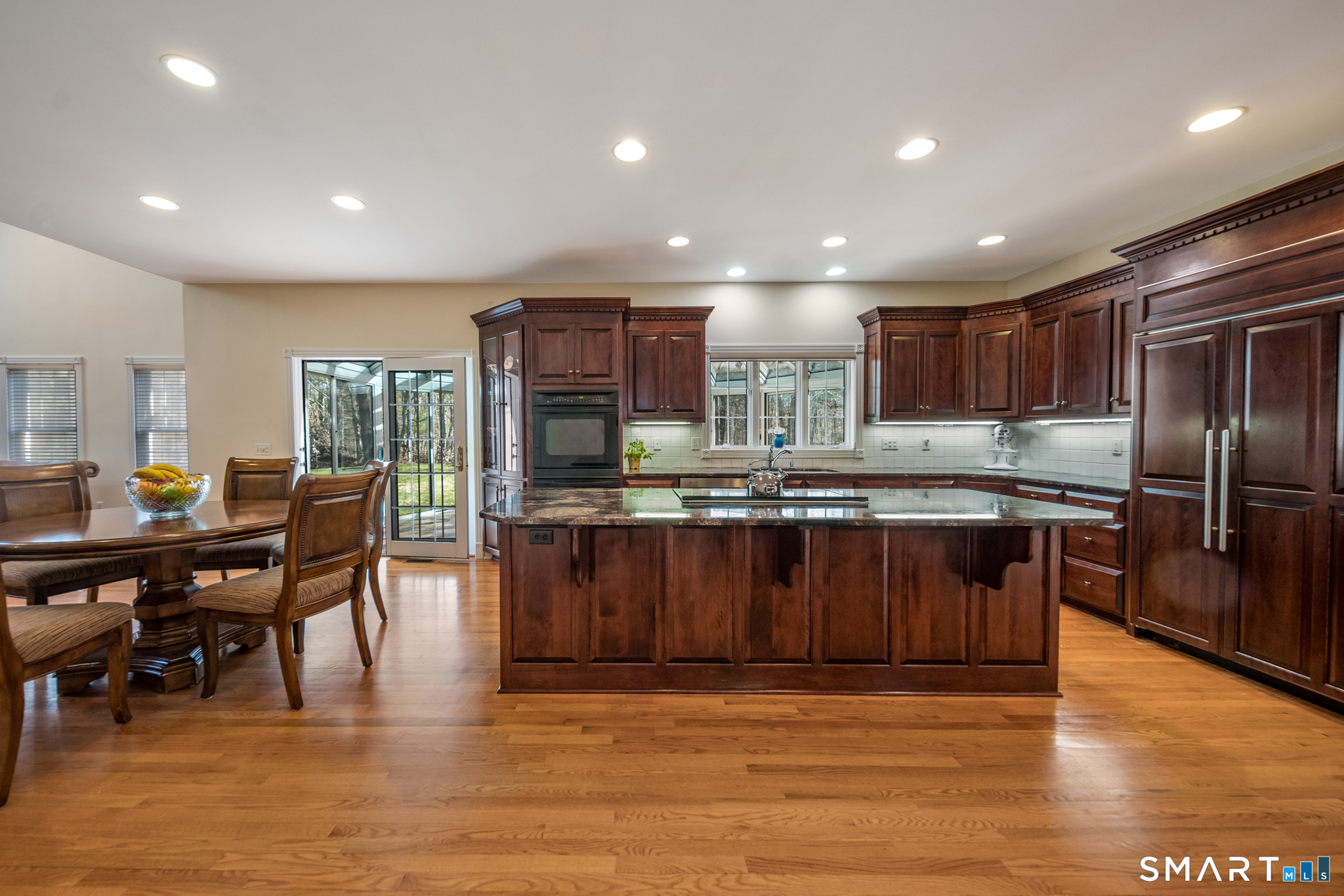 11 Kachina Way Madison, CT 06443 - Photo 14 of 40 a kitchen with stainless steel appliances granite countertop a refrigerator a stove a sink a dining table and chairs