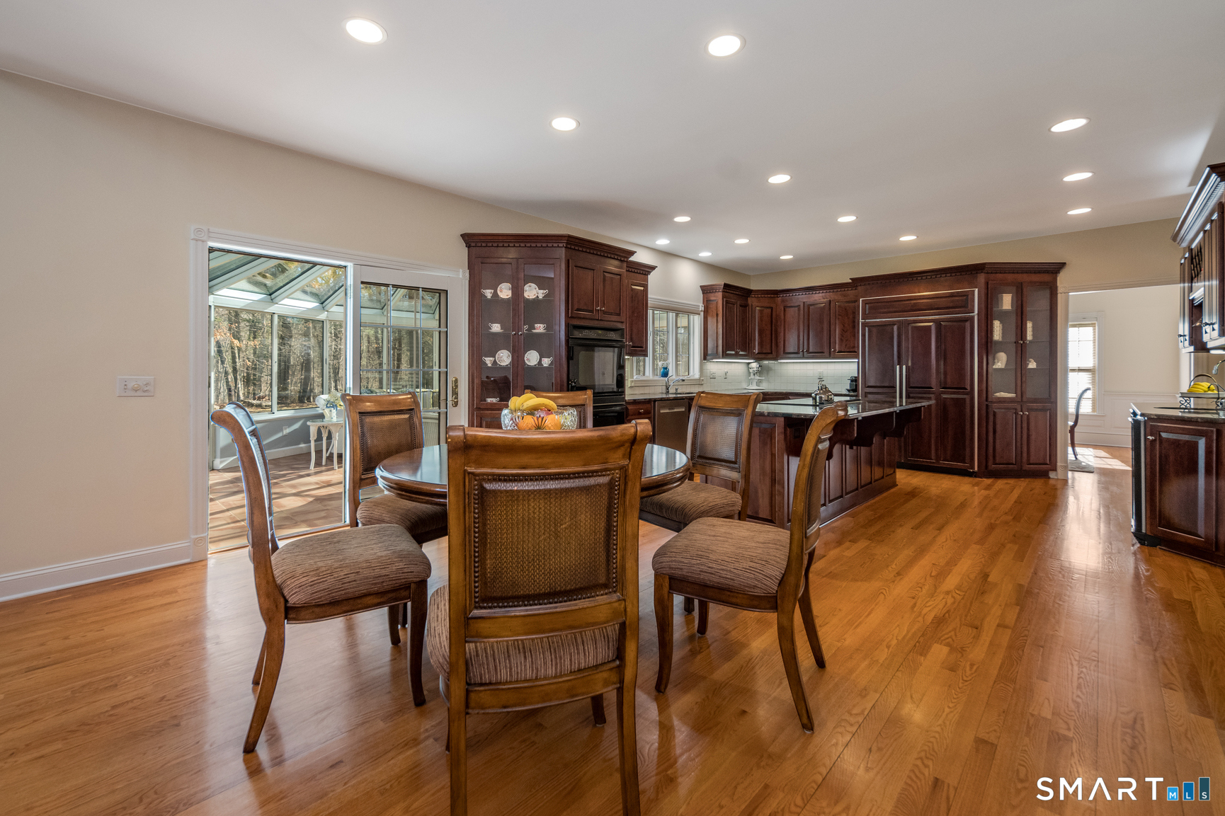 11 Kachina Way Madison, CT 06443 - Photo 16 of 40 a kitchen with a table and chairs in it