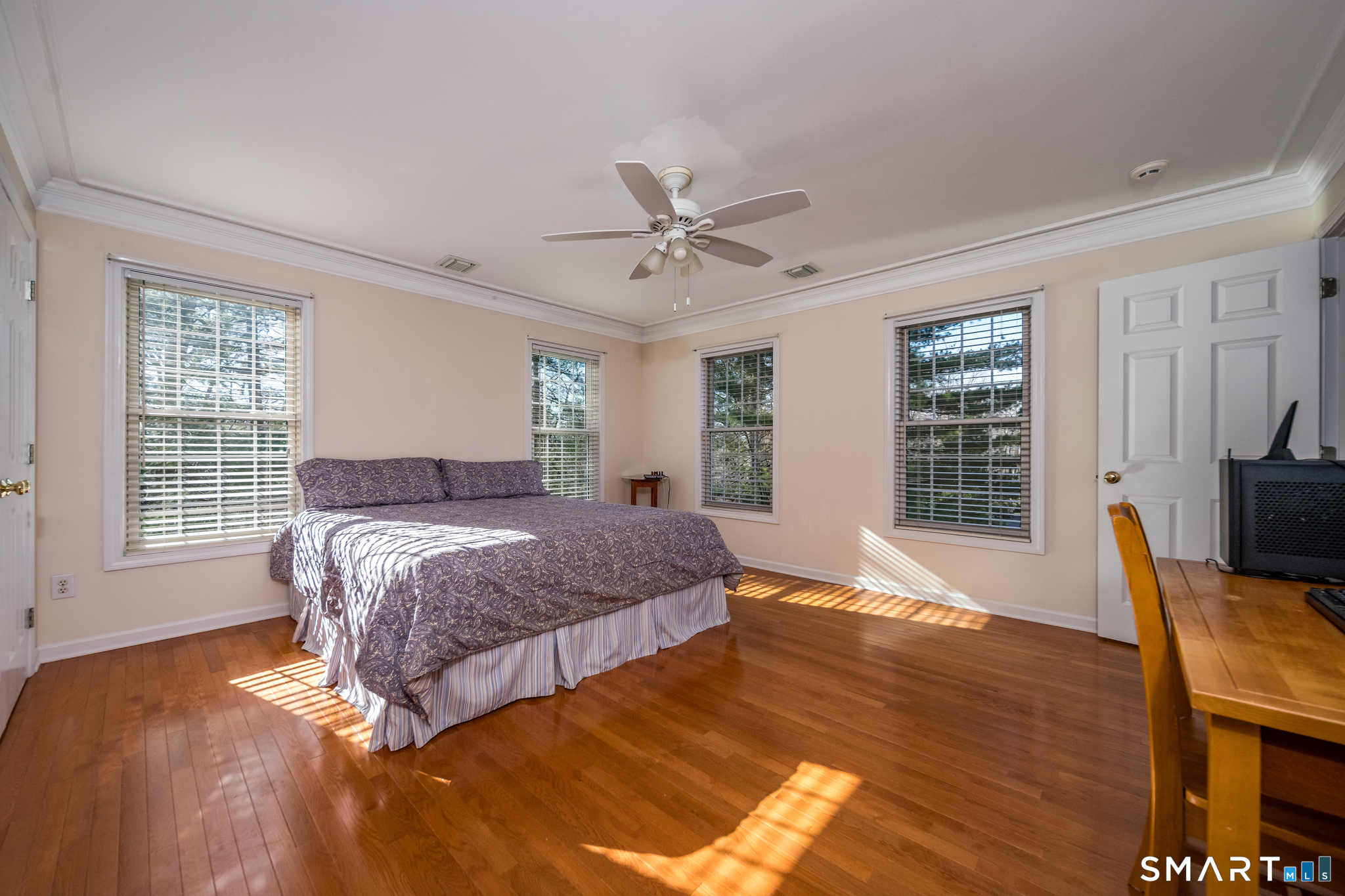 11 Kachina Way Madison, CT 06443 - Photo 25 of 40 a bedroom with a bed and wooden floor