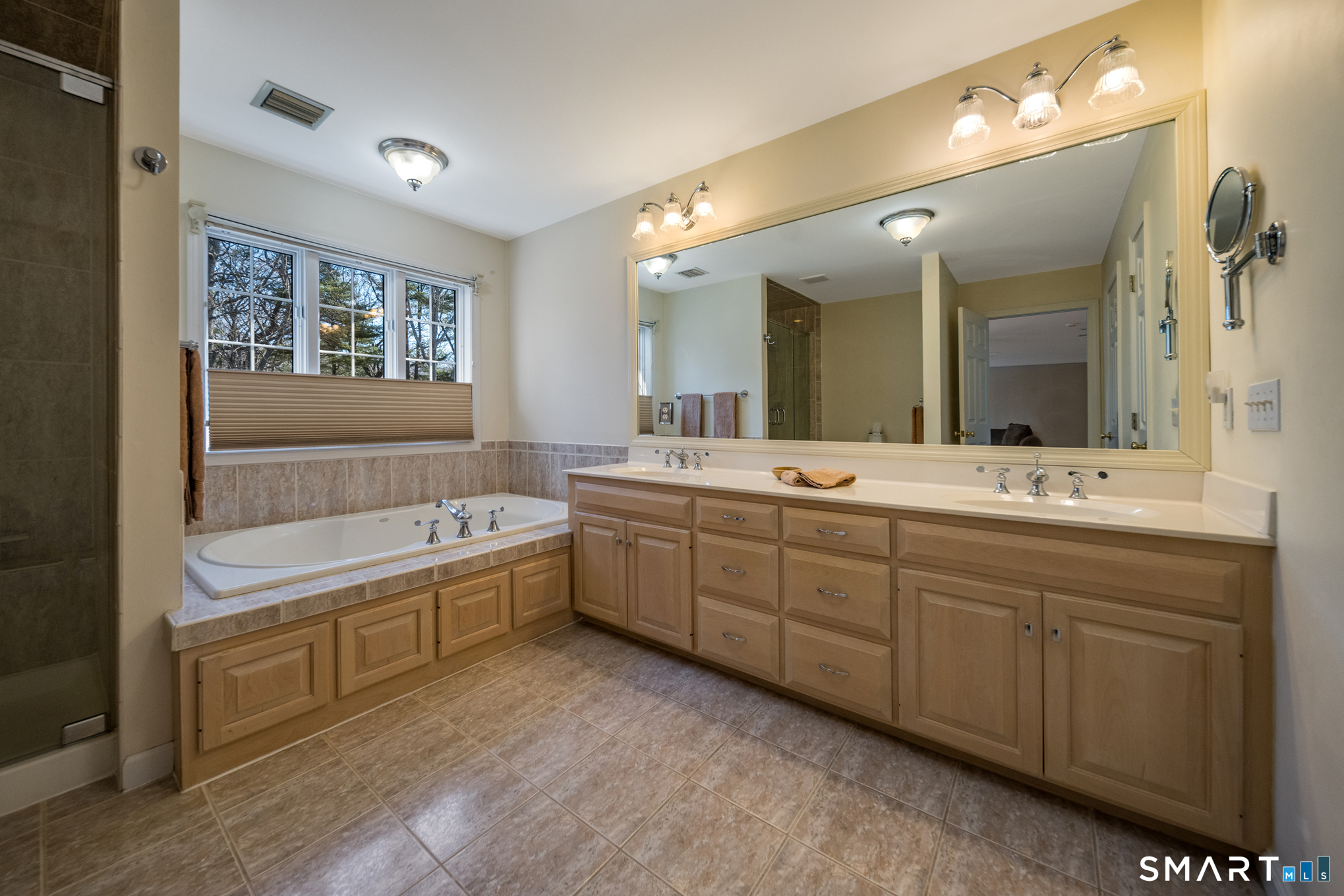 11 Kachina Way Madison, CT 06443 - Photo 26 of 40 a spacious bathroom with a double vanity sink a large mirror and a bathtub