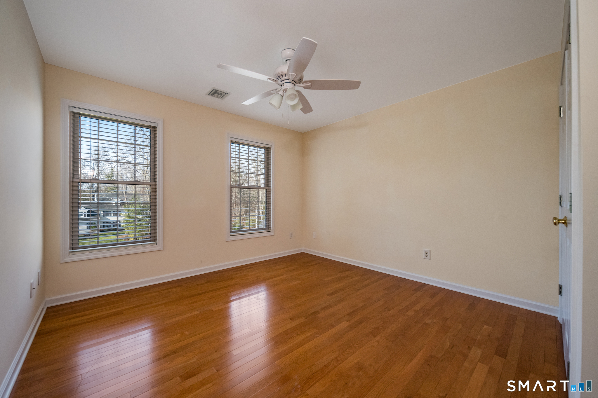 11 Kachina Way Madison, CT 06443 - Photo 28 of 40 an empty room with wooden floor fan and windows